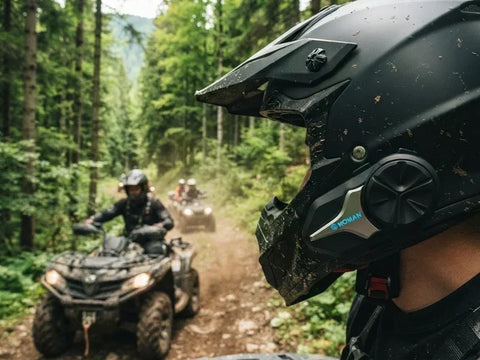 A close-up of an ATV rider wearing a ATV helmet intercom with other riders following