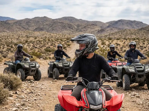 Riders using ATV communication headsets on a desert trail