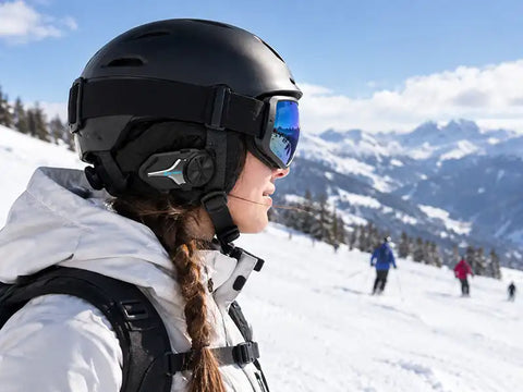 Skier wearing headset for ski helmet on snowy mountains